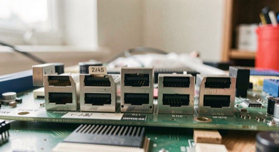 Four expansion slots of increasing length on one motherboard, photographed at a low angle so the retention tab of each is visible