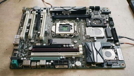 A server motherboard seen from above with its expansion slots, chipset heatsink and processor sockets laid out across the whole board